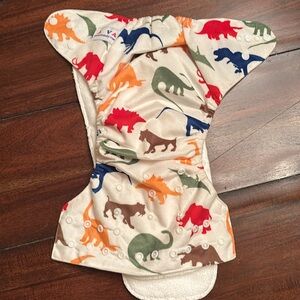 Alva Baby one-size reusable cloth pocket diaper with a dinosaur print